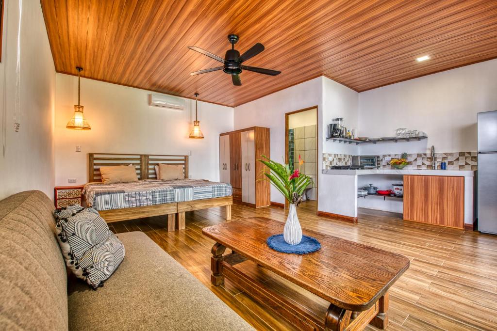 a living room with a couch and a ceiling fan at Beachfront Studio - Direct Beach Access - Fast Wifi & AC in Cocles