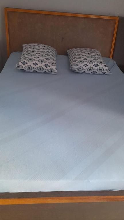 a bed with two pillows on top of it at Hotel Baguari in São Paulo