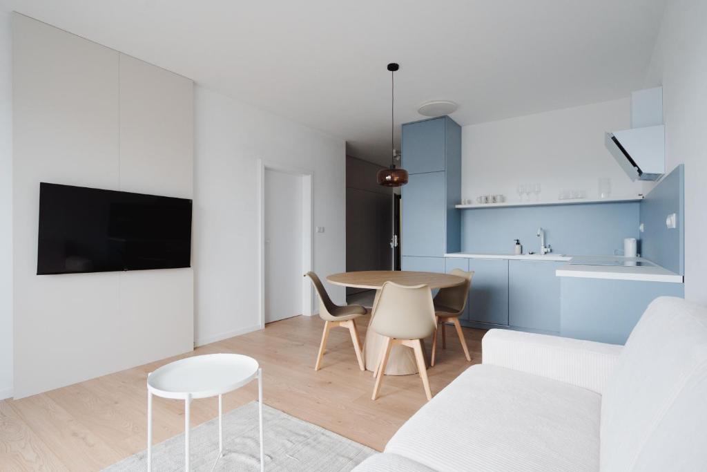 a living room and kitchen with a table and chairs at Castle view Vinetto apartment with free parking in Trenčín