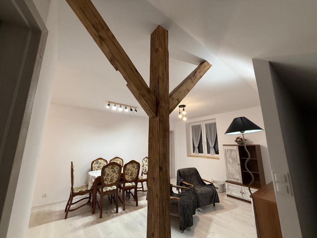a large wooden cross in a living room with a table at Apartament u Buki Zator, Skawina, Kraków in Pozowice