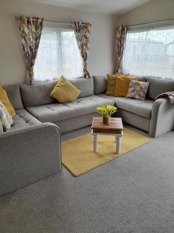 a living room with a couch and a coffee table at The retreat in Carlisle