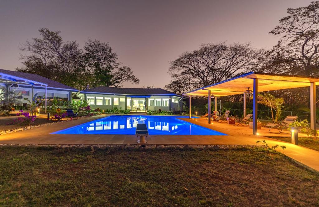 a swimming pool in front of a building at night at Casa Frank - Sophiassuites506 in Brasilito