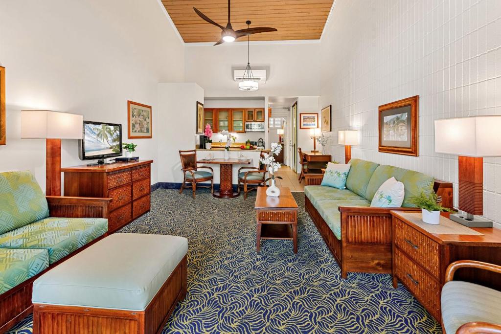 a living room with couches and a dining room at Napili Shores E239 in Lahaina