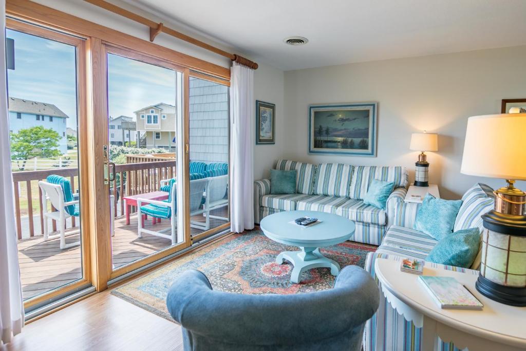 a living room with a couch and a table at 4204 - Outer Thanks in Duck