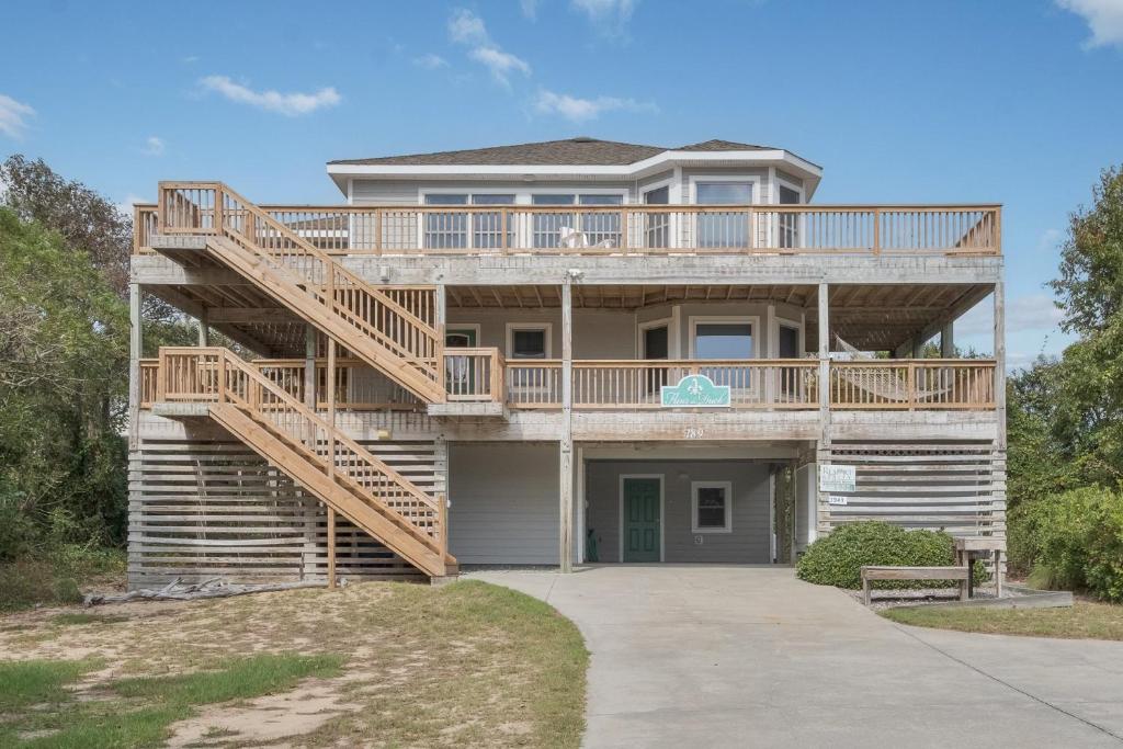 a large house with a wooden spiral staircase at 3941 - Fleur de Duck in Duck
