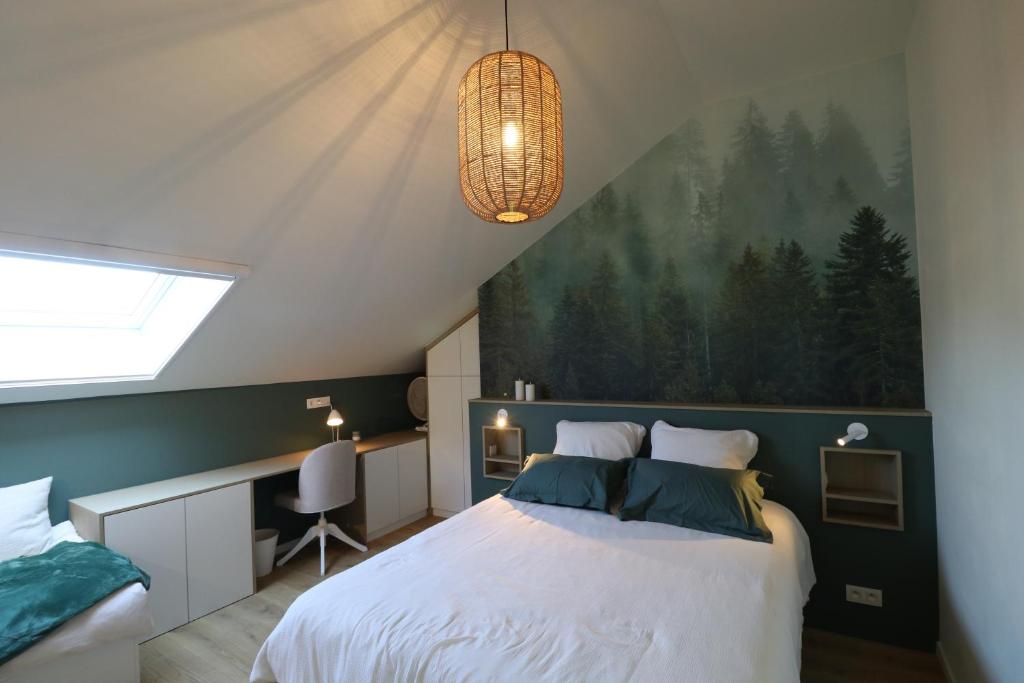 a bedroom with a large bed with a painting on the wall at Chez Martine & Pierre in Baillonville