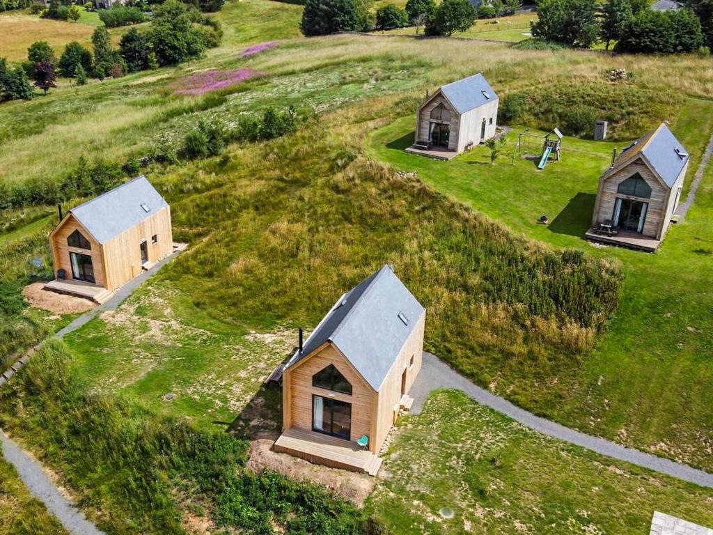 a group of small houses on a grassy hill at Saturn 2 - Uk50472 in Greenhaugh