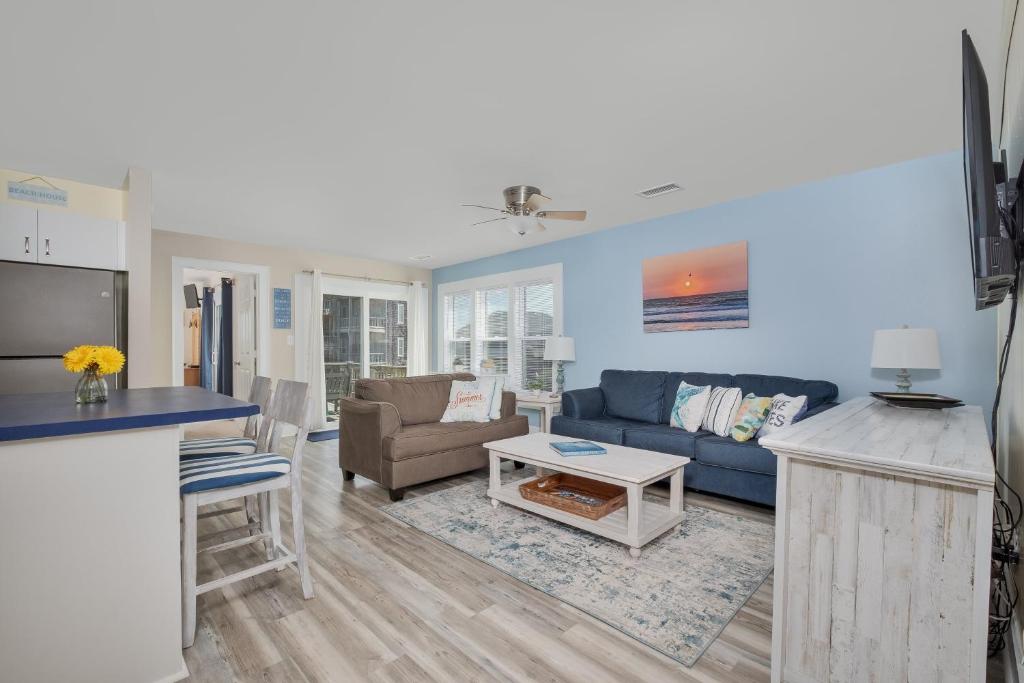a living room with a couch and a table at 7662 - Sea La Vie in Avon