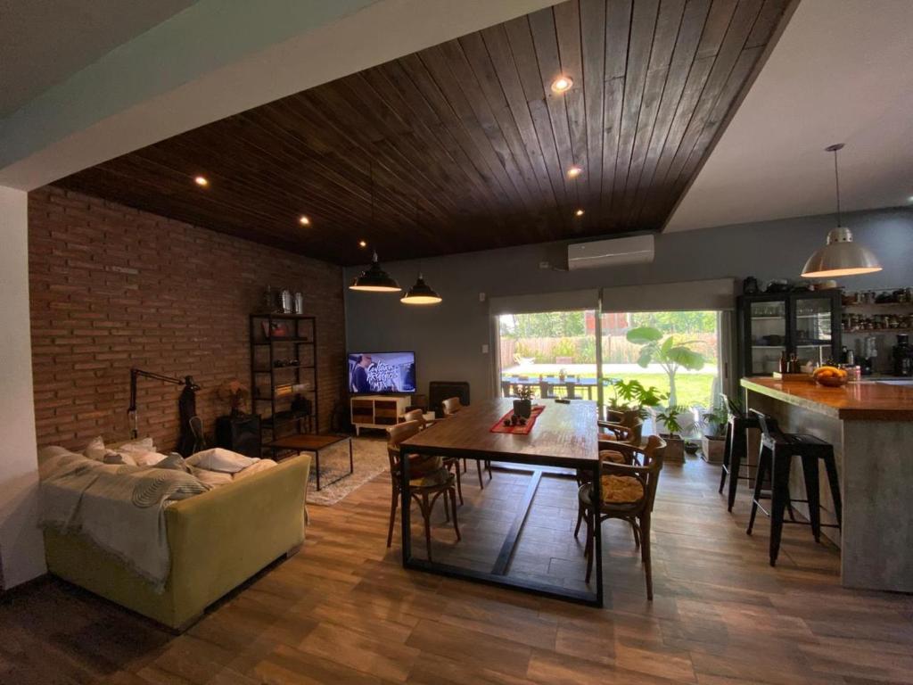 a living room with a couch and a table at Casa Los Nogales in Roldán