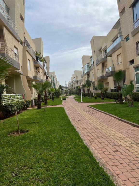 a brick walkway in front of some apartment buildings at DreamCatcher ocean in Mohammedia
