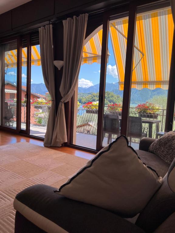 a living room with a couch and large windows at Liza's Suite's - Room's with a View in Sala Comacina