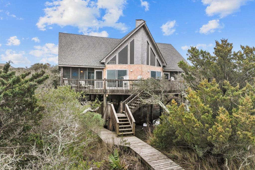 a house on a hill with a wooden staircase at 7828 - Swing Belly's Roost in Frisco