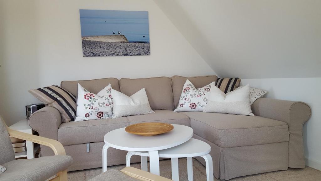 a living room with a couch and a table at FeWo Machedanz mit Balkon Timmendorfer Strand OT Niendorf in Timmendorfer Strand