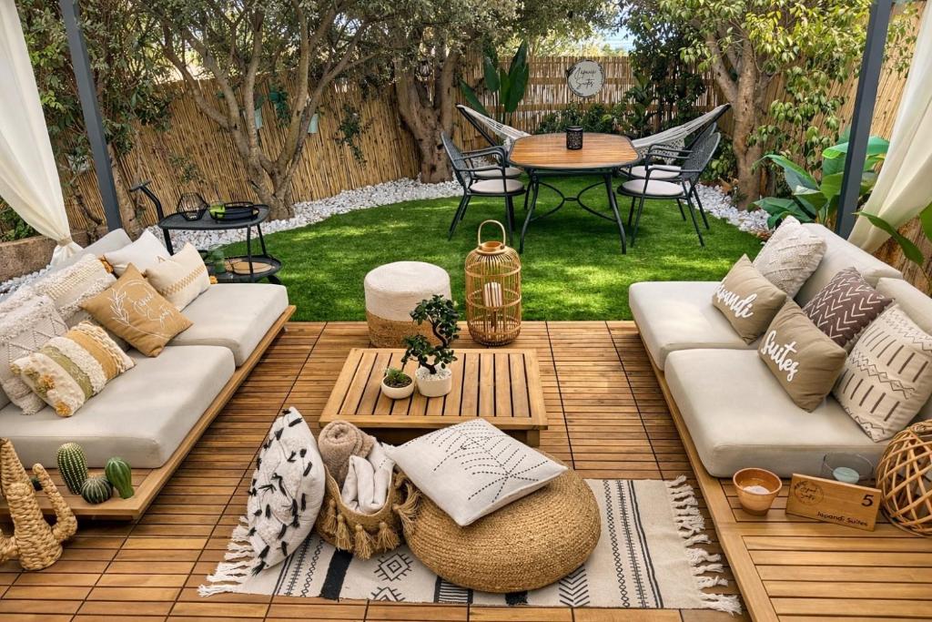 a patio with a couch and a table at Japandi Suites Olbia in Olbia