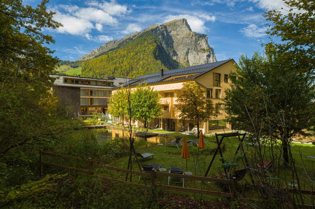 a hotel with a mountain in the background at Hotel Krone in Au in Au im Bregenzerwald