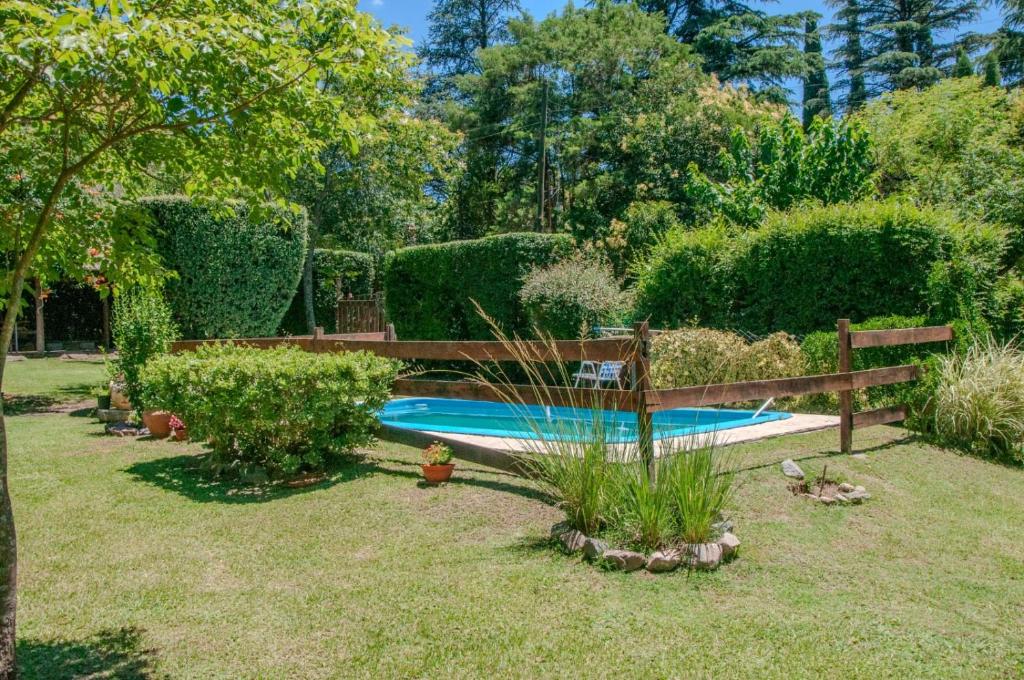 a swimming pool in a yard with a fence at Descanso en Salsipuedes in Salsipuedes