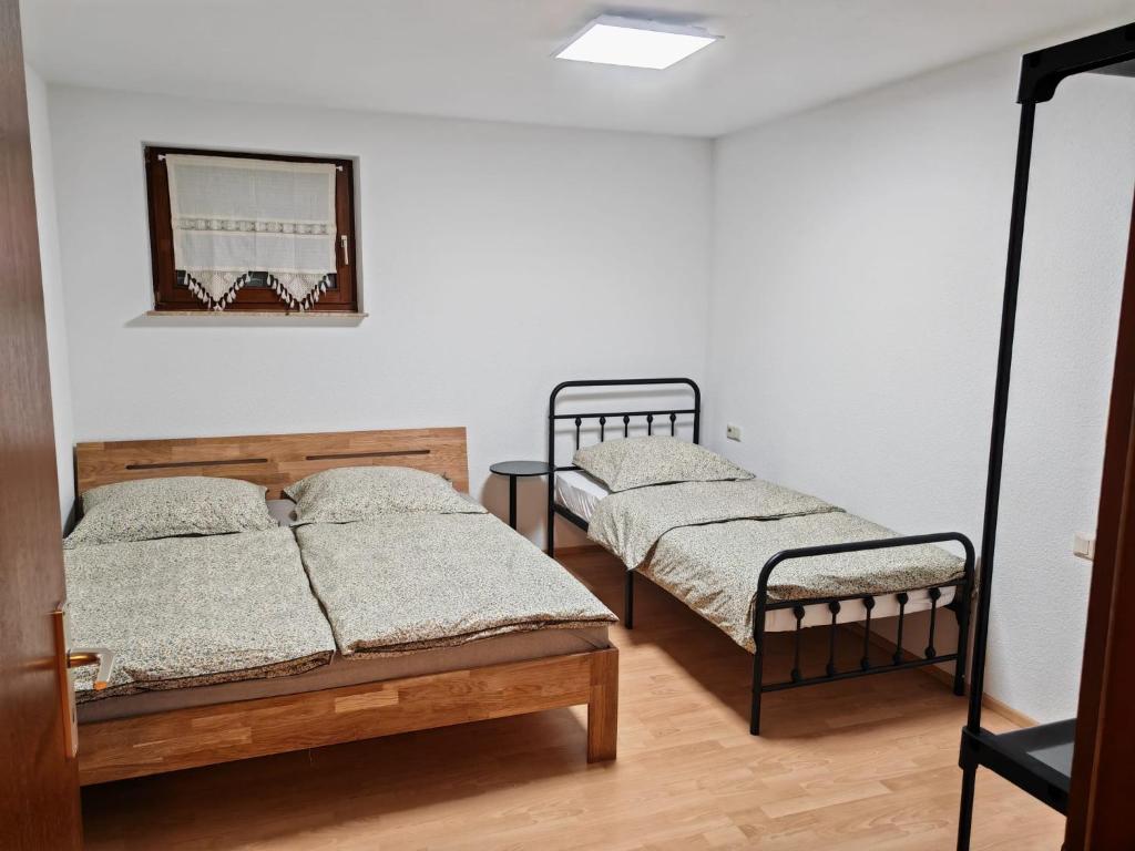 a bedroom with two beds and a mirror at Unterkunft 24 in Aldingen