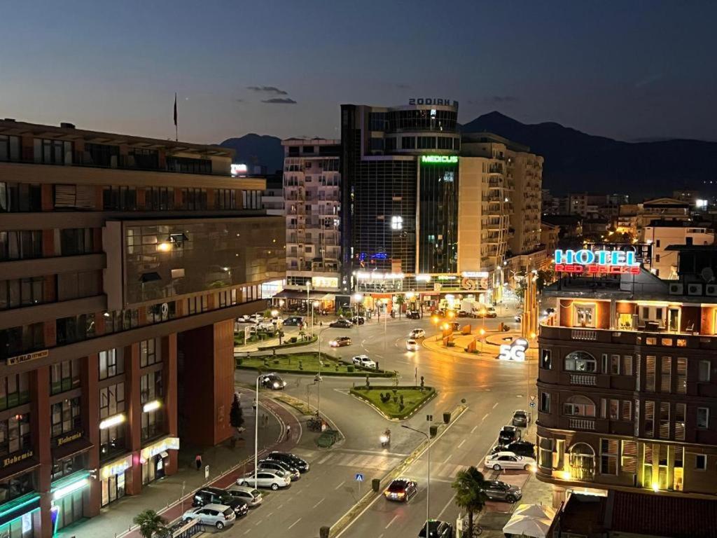 a city at night with cars parked on a street at HORIZONT Central Stay Apart-Hotel in Shkodër