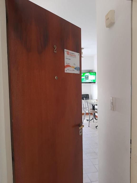 a door in a room with a sign on it at Noche Serena in Puerto Madryn