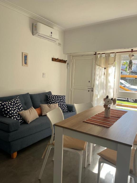a living room with a blue couch and a table at The House in City Bell