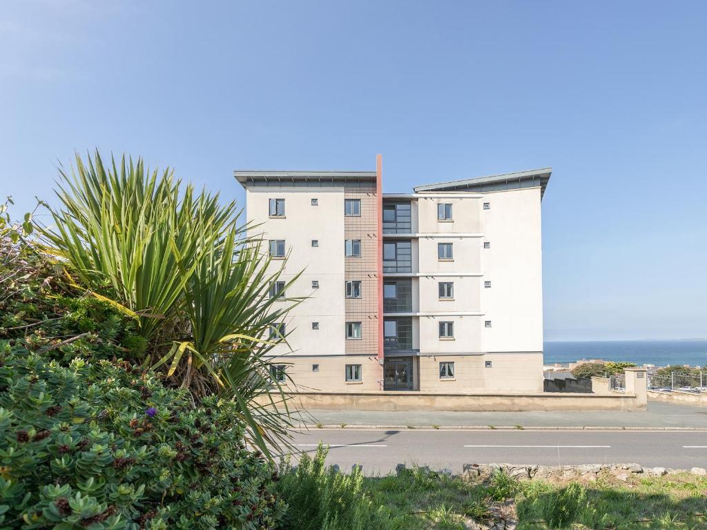 an apartment building with the ocean in the background at Apartment 19 in Newquay