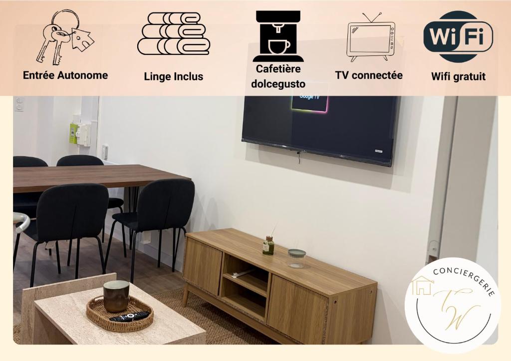 a room with a table and a tv on a wall at Charmant appartement moderne D in La Roche-sur-Yon