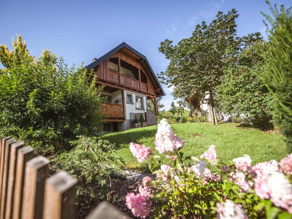 a house with flowers in front of it at Naturpark Chalet Schladming-Dachstein in Großsölk