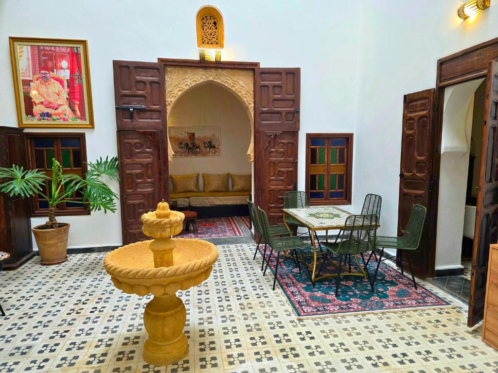 a living room with a table and chairs in it at Riad Boutique Baba in Rabat