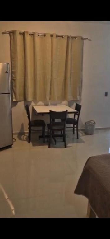 a kitchen with a table and chairs and a window at Suites Destination in Cuatrociénegas de Carranza