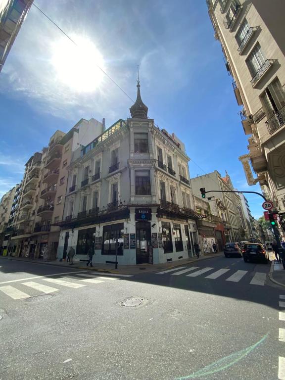 a large white building on a city street at Hostel Las Lengas in Buenos Aires