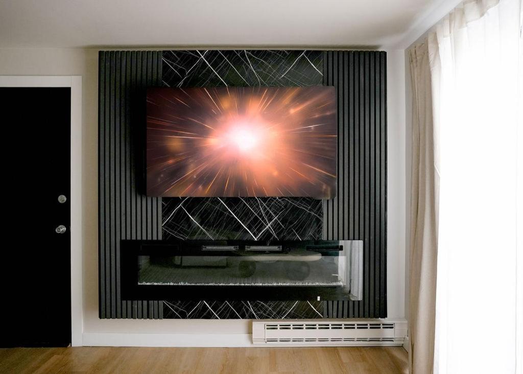 a flat screen tv on a wall in a living room at Modern 1BR w/ Workspace near O'Hare in Chicago