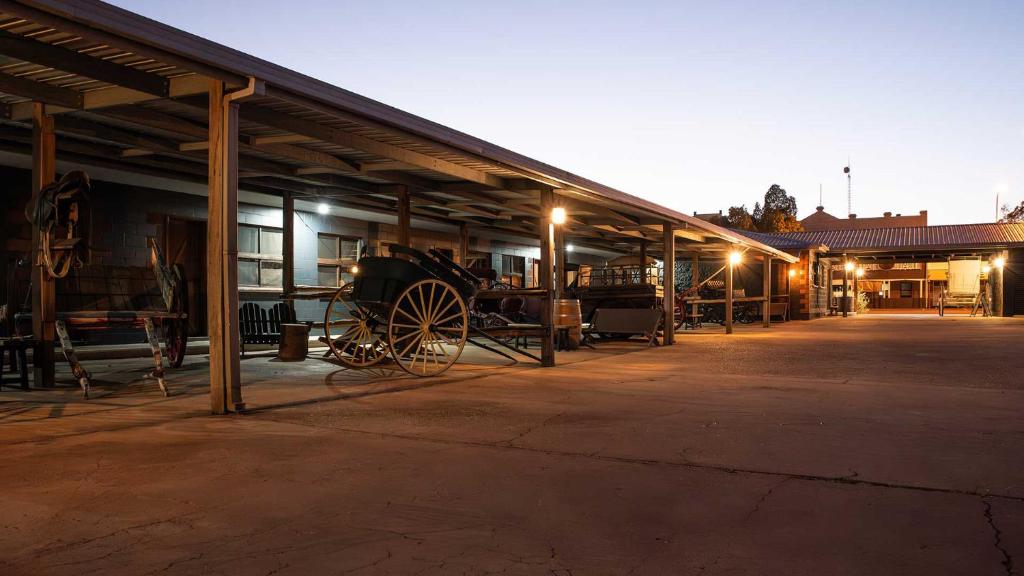an old barn with a wagon parked in it at The Staging Post in Longreach