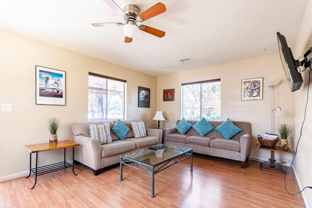 a living room with two couches and a ceiling fan at Old Town Cottonwood Cottage in Cottonwood