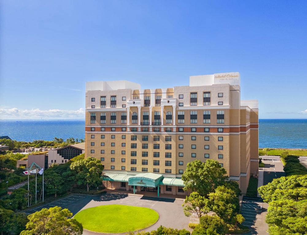 an aerial view of a hotel with the ocean in the background at Hotel Okura Tokyo Bay in Urayasu
