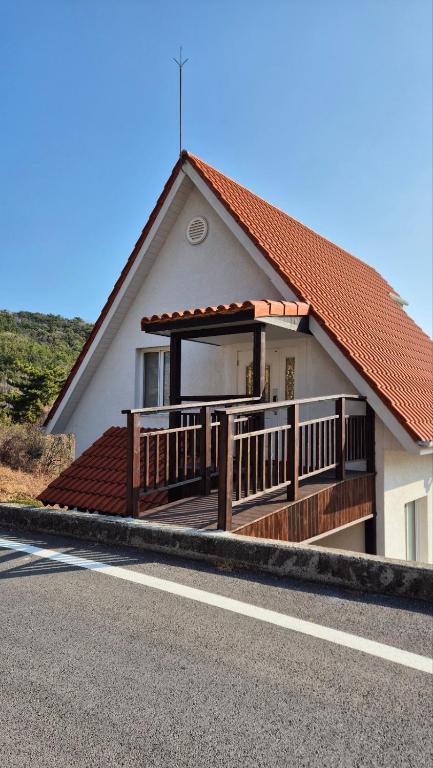 a house with a large deck on the side of it at 남해독일마을드레스덴 in Samhwa-dong