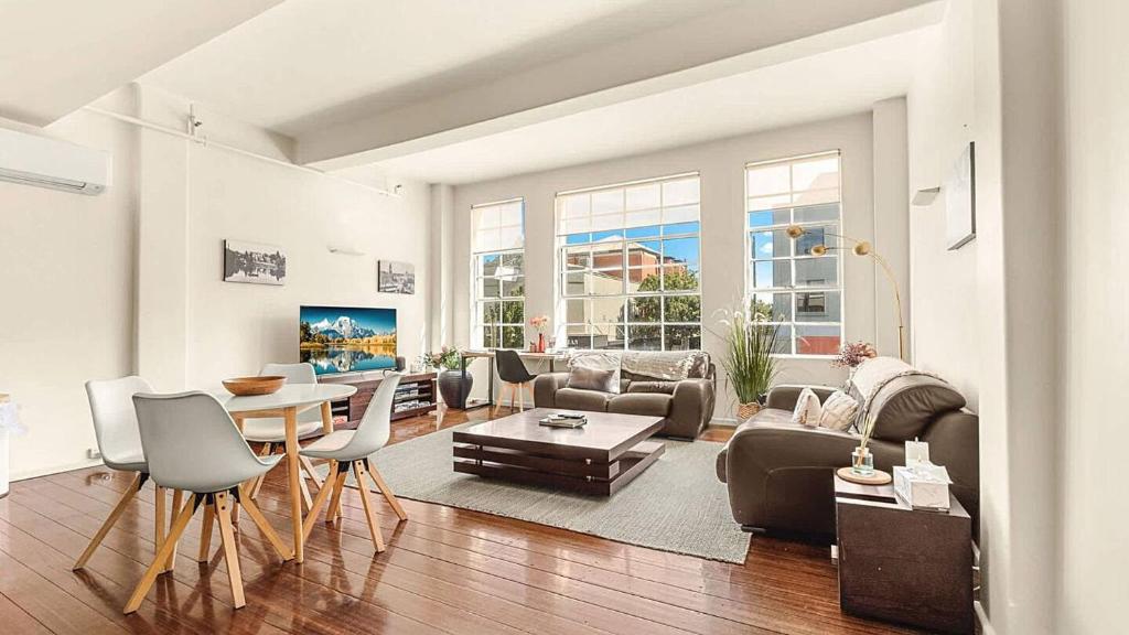 a living room with a couch and a table at New York Style Apartment in Bendigo