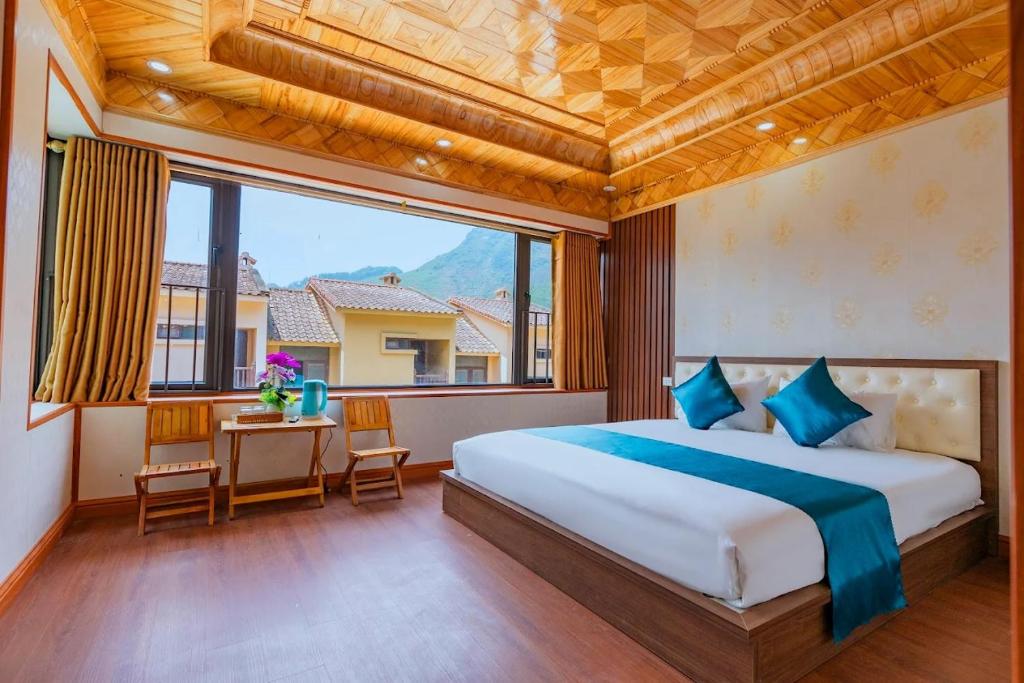 a bedroom with a large bed and a large window at Bong's House Sapa in Sapa
