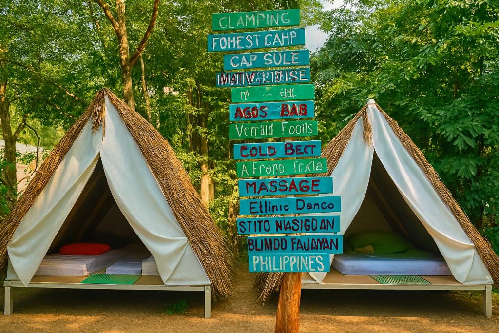 a sign in front of a tent with a bed at Kapsula El Nido in El Nido