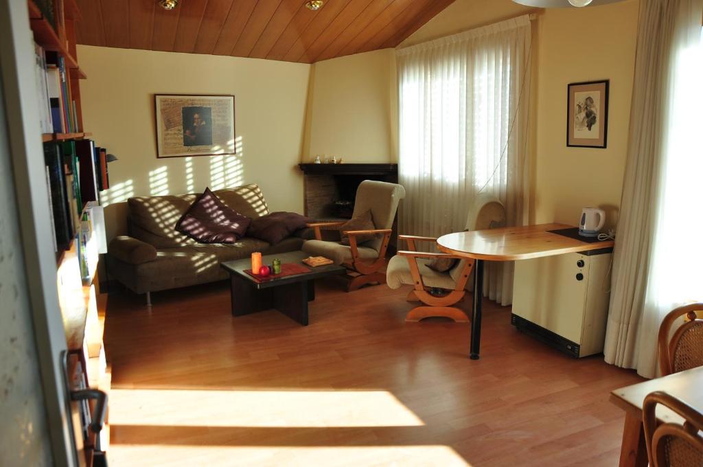 a living room with a couch and a table at Can Déu del Firal in Cassà de la Selva