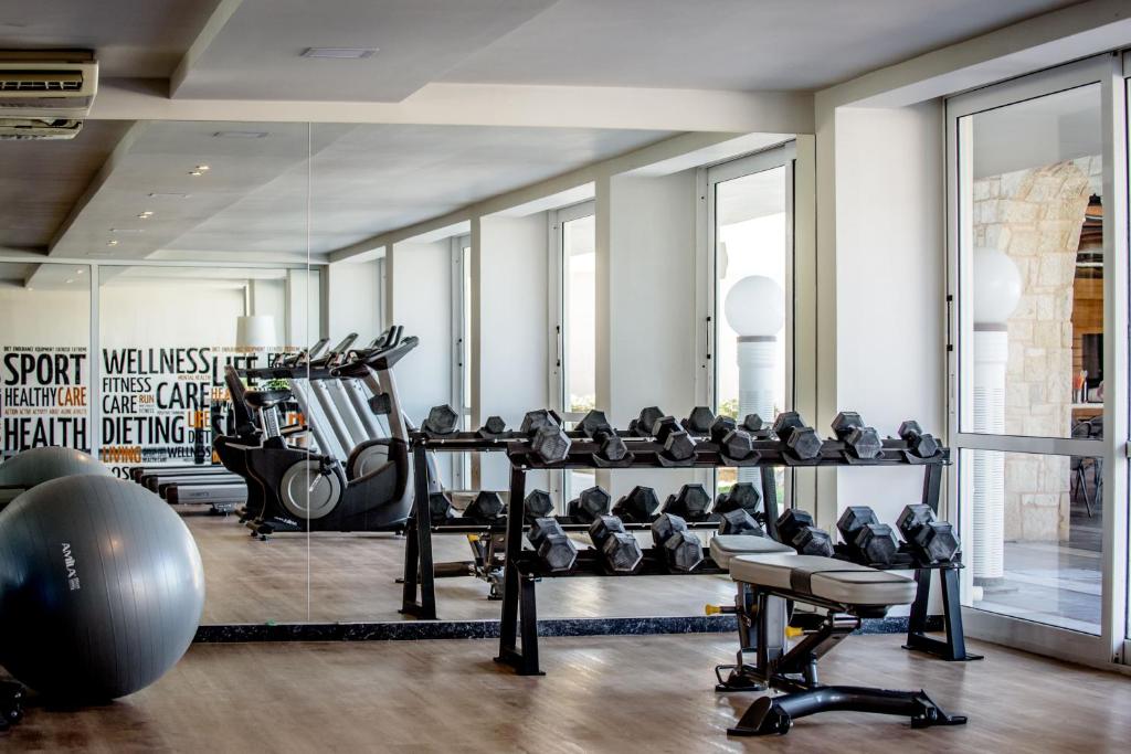 a gym with a lot of equipment in a room at SOL by Meliá Marina Beach Crete in Gouves