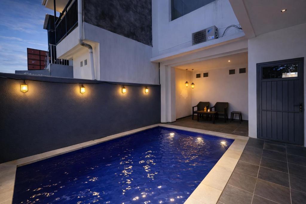 a swimming pool in the middle of a house at Sanur House Lavender in Sanur