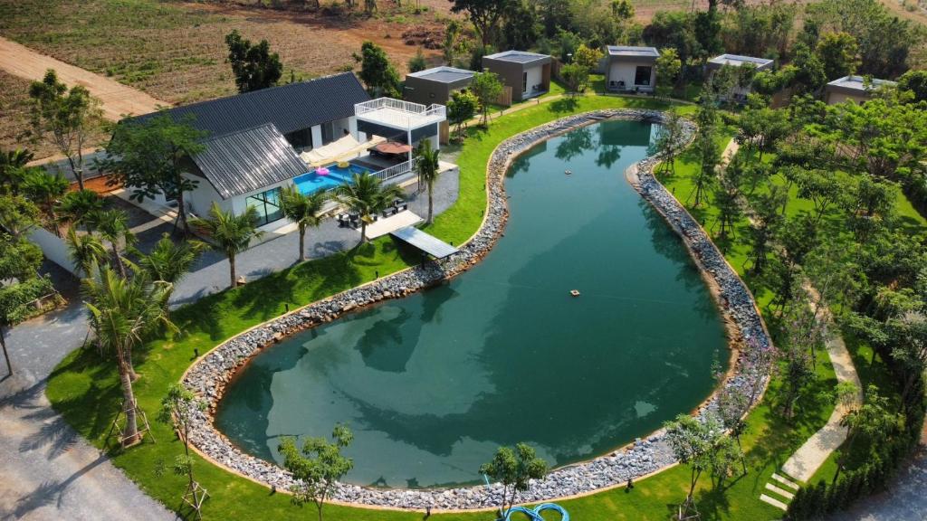 an aerial view of a pool at a resort at The Forest Pool villa & cafe in Ban Wang Yao