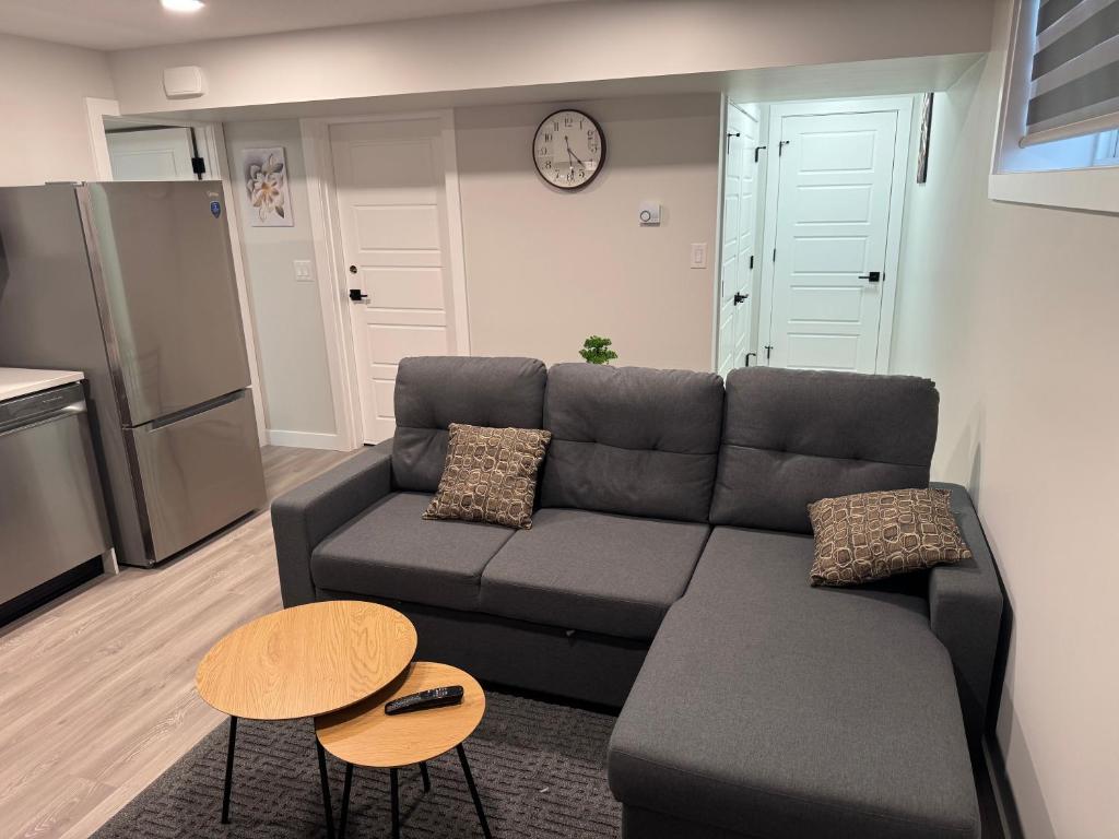 a living room with a couch and a table at Alake Villa in Saskatoon