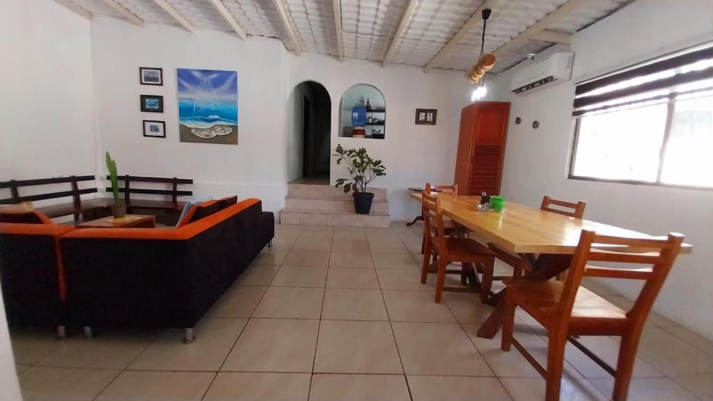 a dining room with a table and a couch at Genovesa Family home in Puerto Ayora