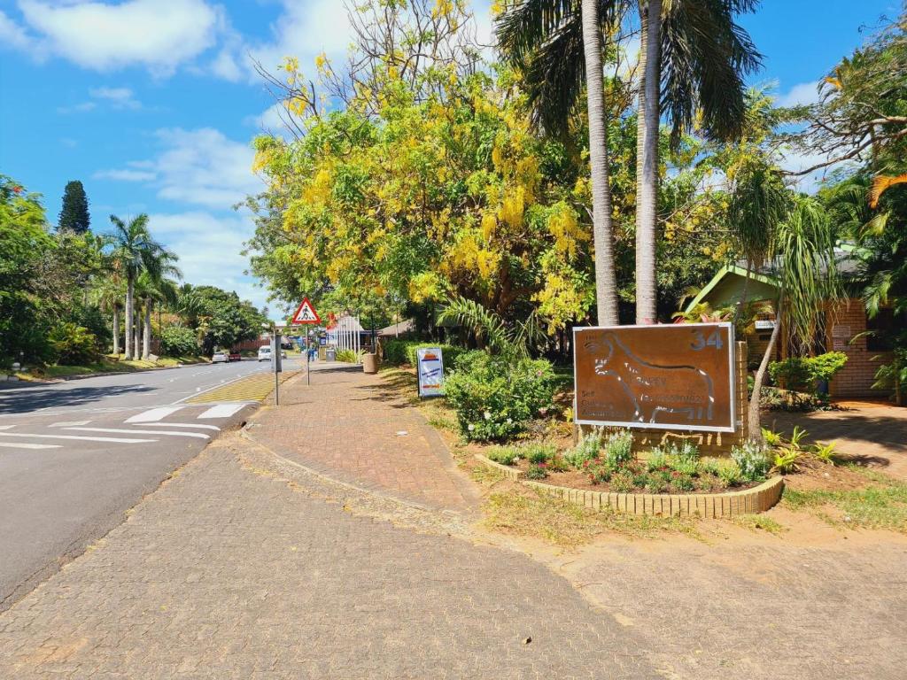 a sign sitting on the side of a street at The Estuary Guest Chalets in St Lucia