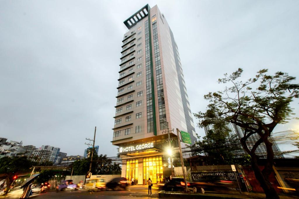 a tall building with a sign on the side of it at Hotel George in Cebu City