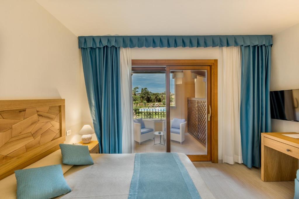 a hotel room with a bed and a balcony at Hotel Marana in Golfo Aranci