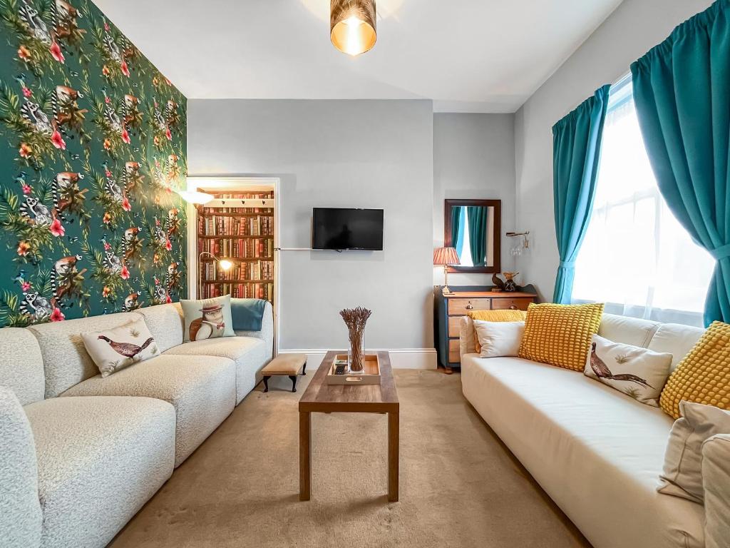 a living room with a couch and a table at The Badger Sett in Hinderwell