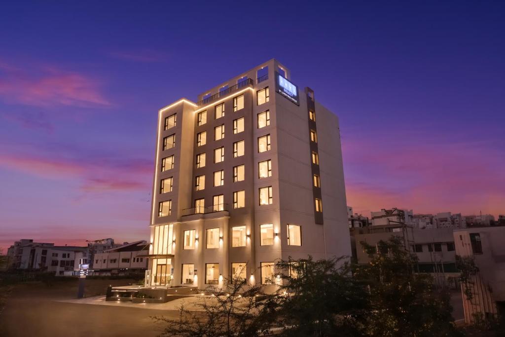 a tall building with a clock on top of it at Keys Select By Lemon Tree Hotels, Vadodara in Vadodara