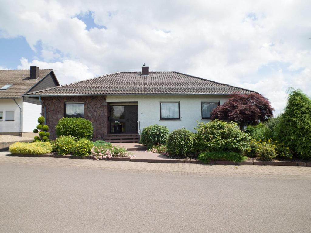 a white house with bushes in front of it at Ferienwohnung Alexandra in Mettlach